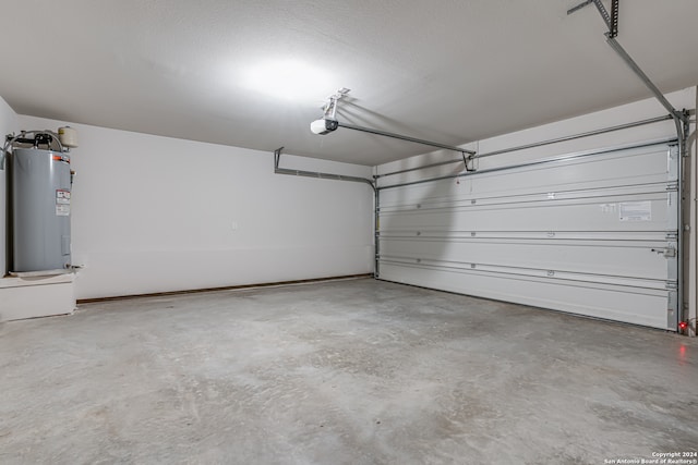 garage with electric water heater and a garage door opener