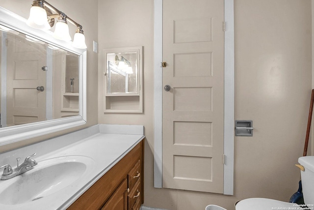 bathroom with vanity and toilet