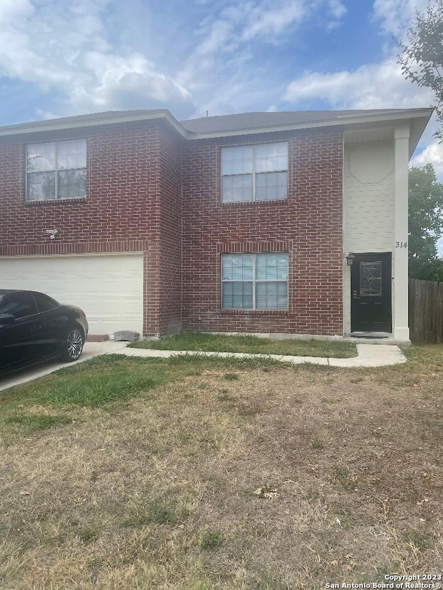 view of front of home featuring a front yard and a garage