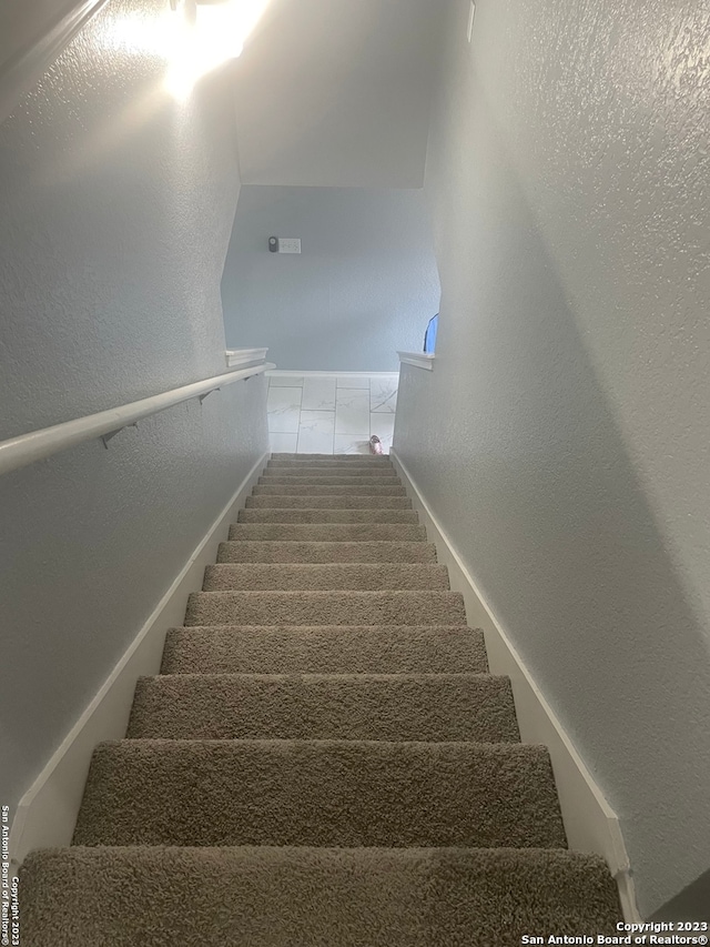 staircase featuring tile flooring