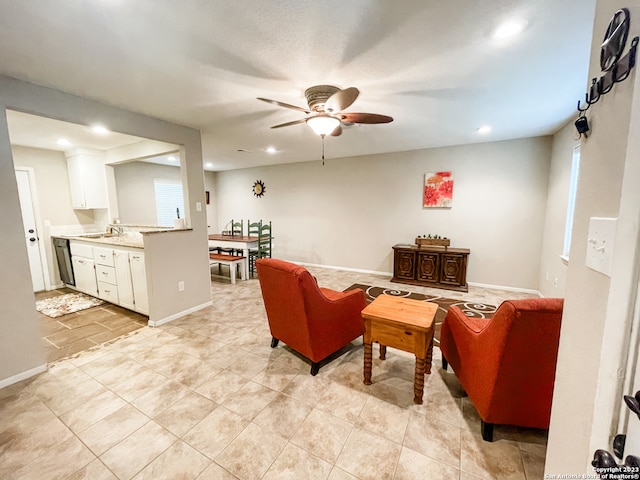 living room with ceiling fan, sink, and light tile floors