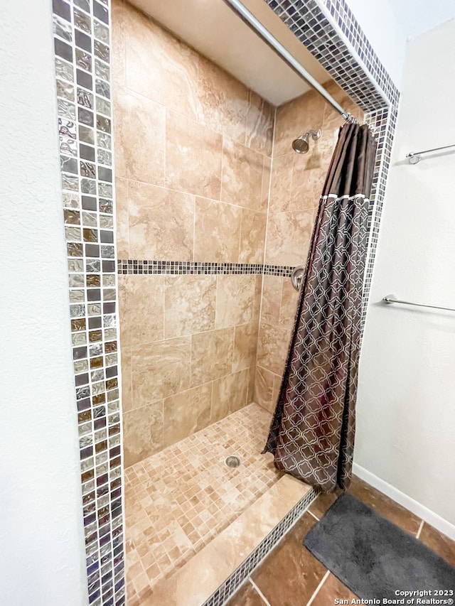 bathroom with tile flooring and a shower with shower curtain