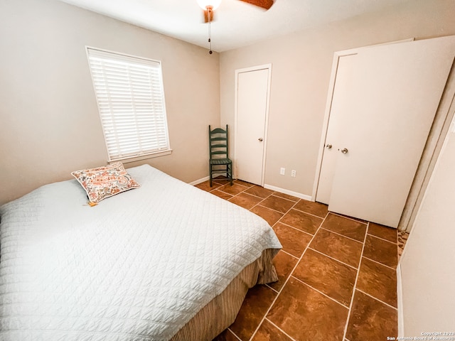 tiled bedroom with ceiling fan