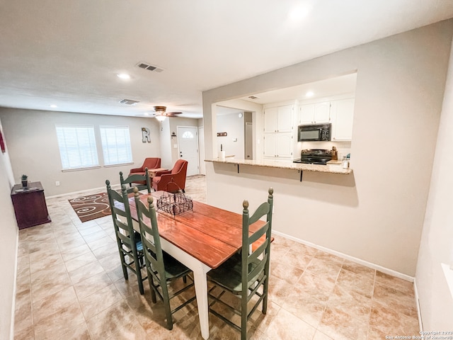 dining area with light tile floors and ceiling fan