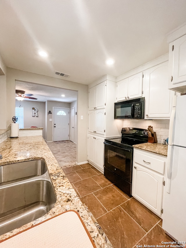 kitchen with ceiling fan, tasteful backsplash, black appliances, white cabinetry, and dark tile floors