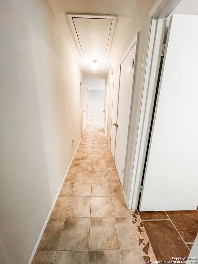 corridor featuring light tile floors