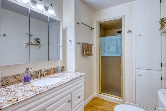 bathroom with toilet, tile floors, an enclosed shower, and vanity