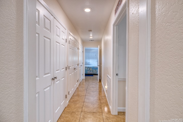 hall with light tile floors