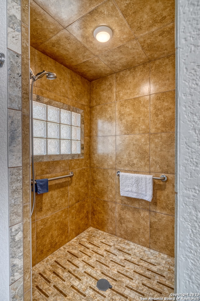 bathroom with a tile shower