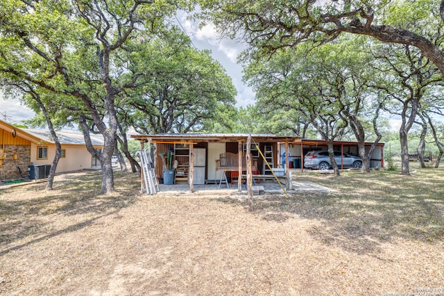 rear view of property featuring central AC unit