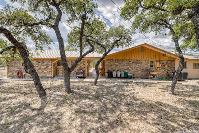 view of front of property featuring central AC and a patio