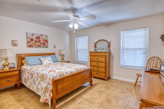 tiled bedroom featuring ceiling fan