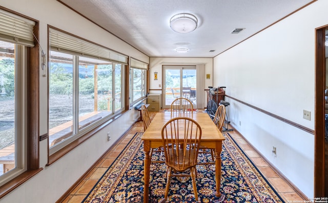 dining room featuring light tile floors and a textured ceiling