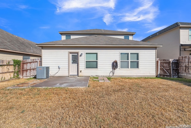 back of property with central AC, a yard, and a patio area