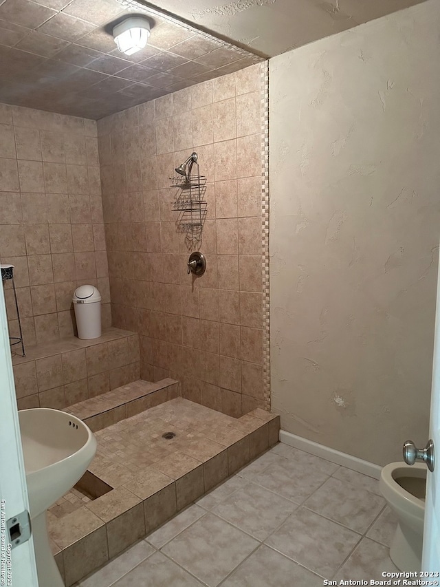 bathroom featuring tile walls, toilet, a tile shower, and tile flooring