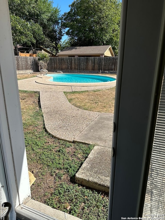 view of yard with a fenced in pool and a patio