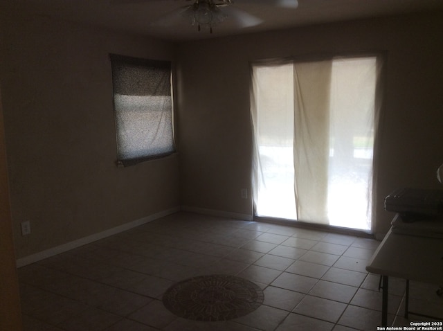 spare room with ceiling fan and tile flooring