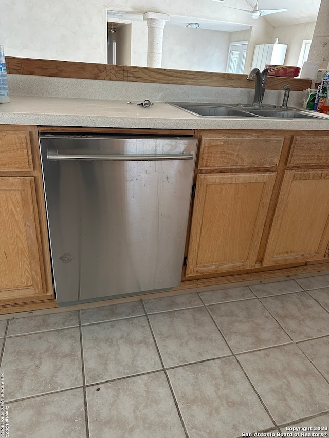 kitchen with sink, light tile floors, and dishwasher