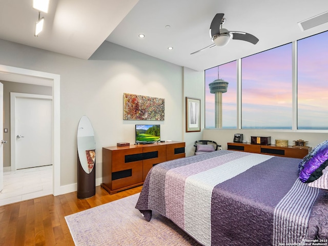 bedroom with light hardwood / wood-style floors and ceiling fan