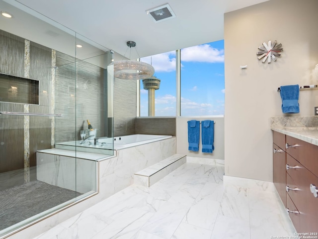 bathroom featuring tile floors, separate shower and tub, and vanity