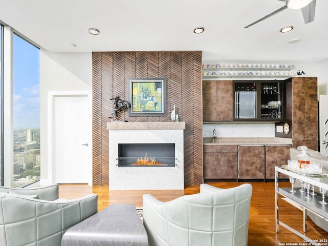 living room with wood-type flooring and ceiling fan