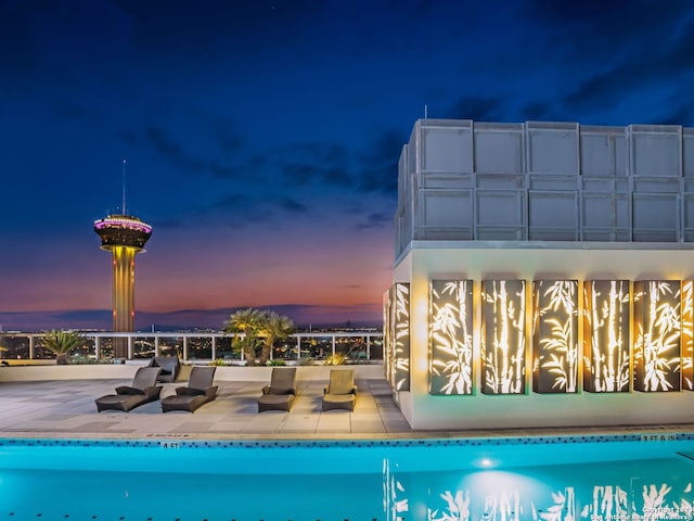 view of pool at dusk