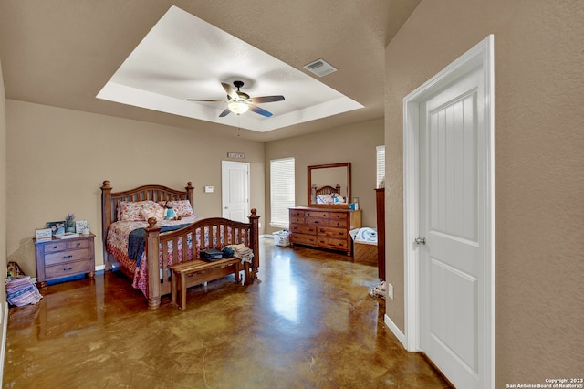 bedroom with a tray ceiling and ceiling fan