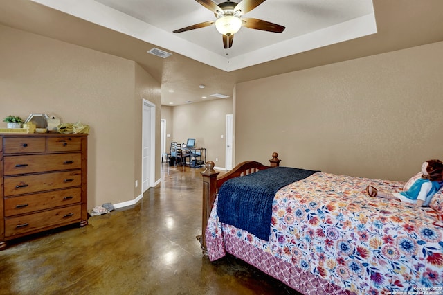 bedroom featuring ceiling fan and a tray ceiling