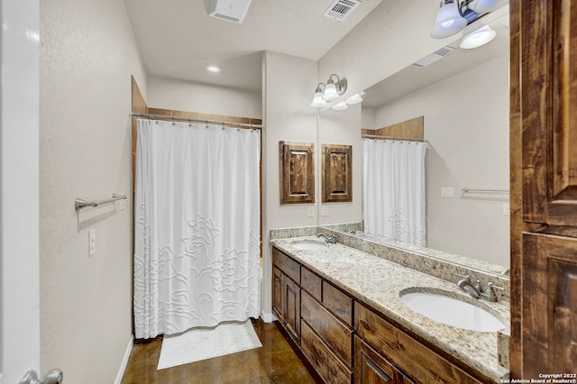 bathroom with double sink vanity and tile flooring