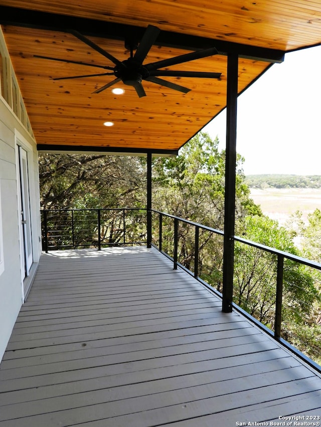 wooden terrace featuring a ceiling fan