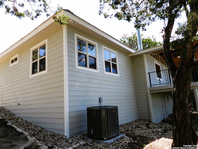 view of property exterior featuring a balcony and central air condition unit