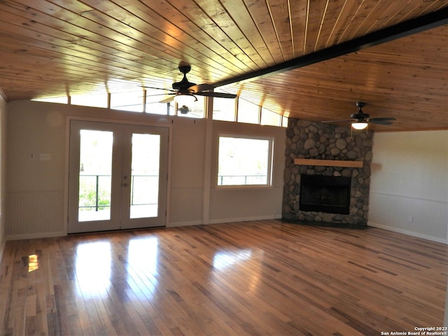 unfurnished living room featuring wainscoting, a fireplace, and hardwood / wood-style floors