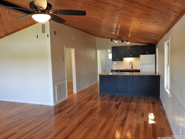 kitchen featuring wooden ceiling, vaulted ceiling, a sink, and freestanding refrigerator