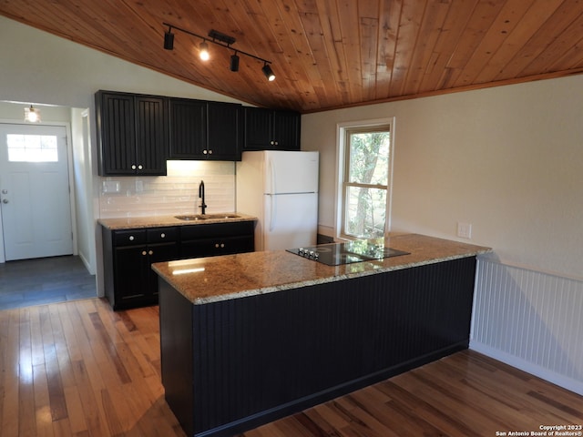 kitchen featuring freestanding refrigerator, wood ceiling, a sink, dark cabinets, and black electric cooktop