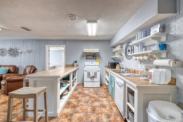 kitchen with light tile floors, a kitchen bar, a textured ceiling, white appliances, and sink