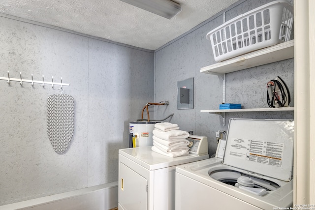 laundry area with a textured ceiling, electric water heater, and washing machine and clothes dryer