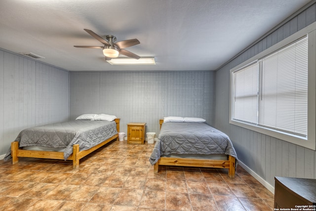 bedroom with ceiling fan and light tile flooring