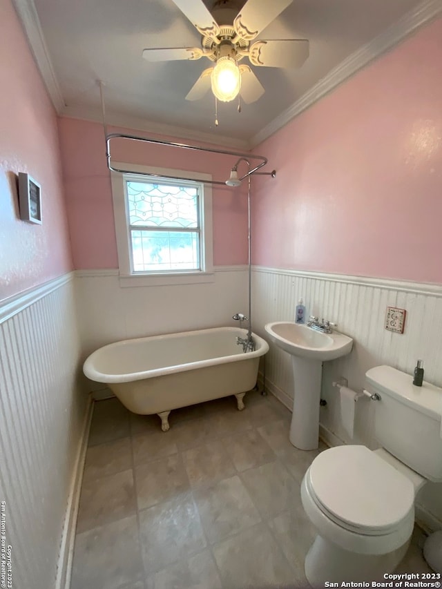 bathroom featuring toilet, ceiling fan, crown molding, tile flooring, and a bathtub