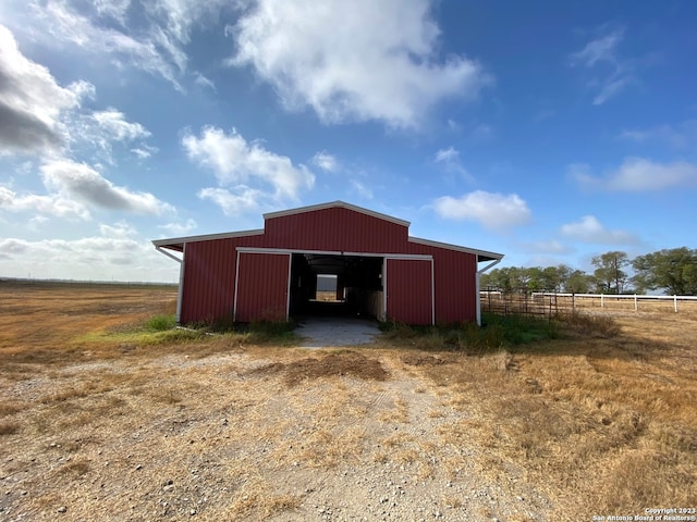 view of outdoor structure with a rural view