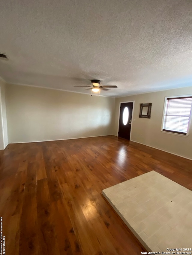 foyer featuring a textured ceiling, ceiling fan, and hardwood / wood-style flooring