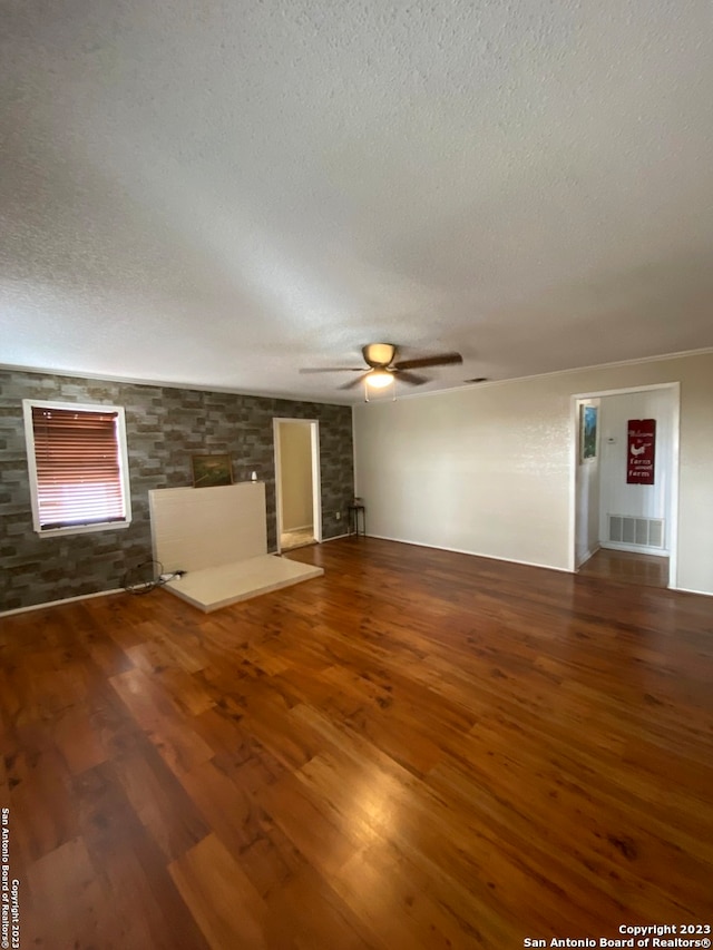 unfurnished living room with dark hardwood / wood-style floors, a textured ceiling, and ceiling fan