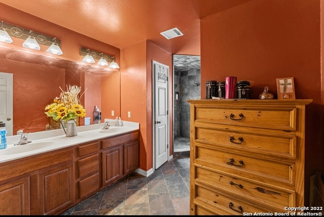 bathroom featuring tile floors and dual bowl vanity