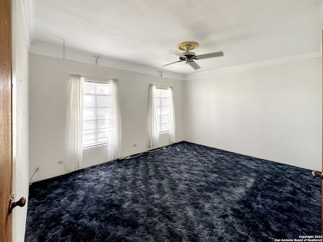 carpeted spare room with crown molding and ceiling fan