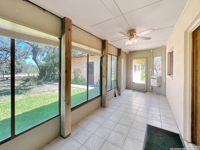 unfurnished sunroom featuring ceiling fan and cooling unit