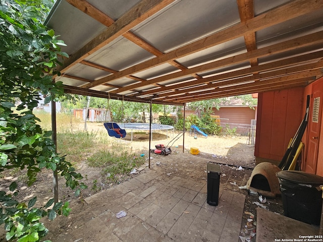 view of patio featuring an outdoor structure and a trampoline