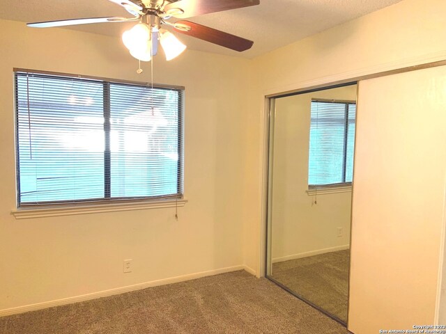 interior space with ceiling fan