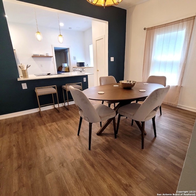 dining area with dark hardwood / wood-style floors