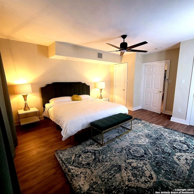 bedroom featuring dark hardwood / wood-style flooring and ceiling fan