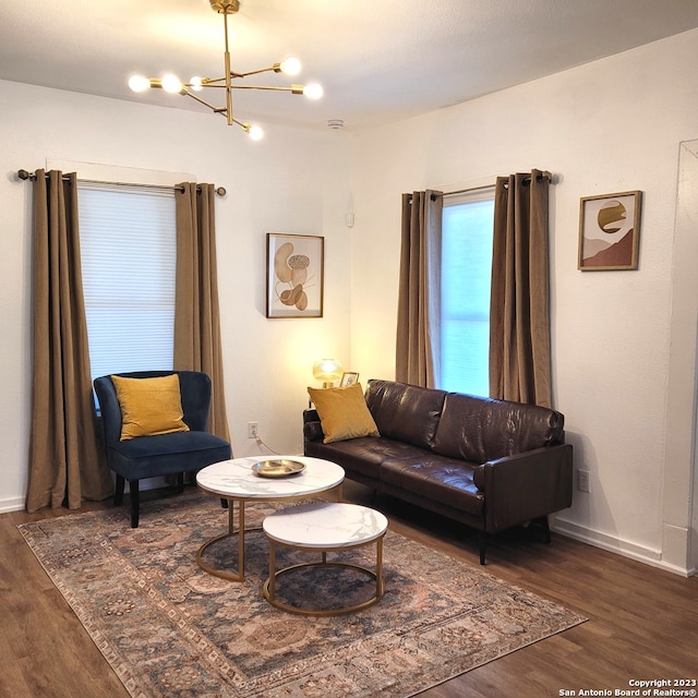 living room featuring a notable chandelier and dark hardwood / wood-style floors