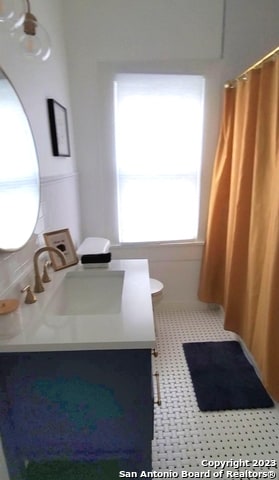 bathroom with large vanity and tile flooring